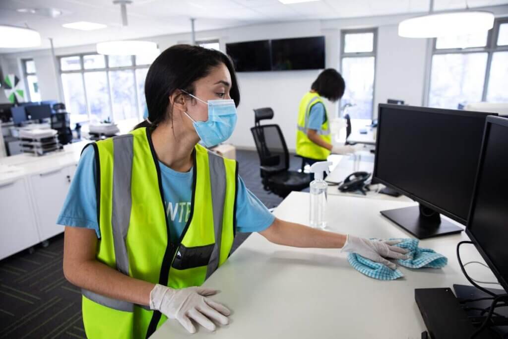 woman wearing hi vis vest and face mask cleaning t 2023 11 27 04 49 08 utc 1